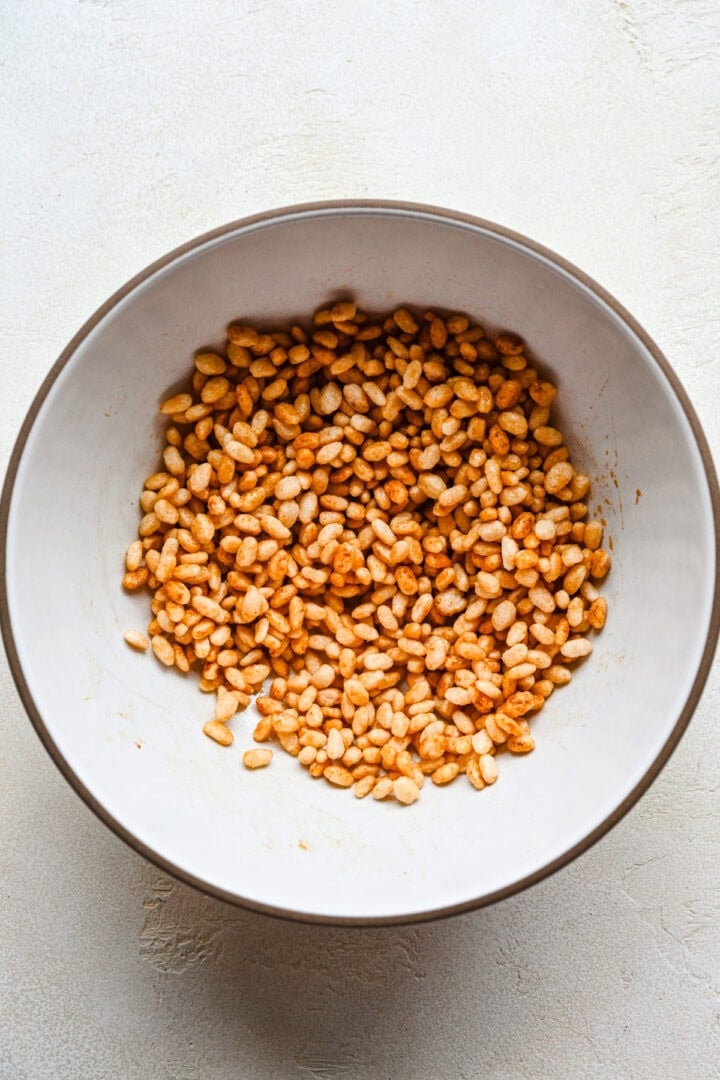 Overhead view of puffed rice, coated in spices.