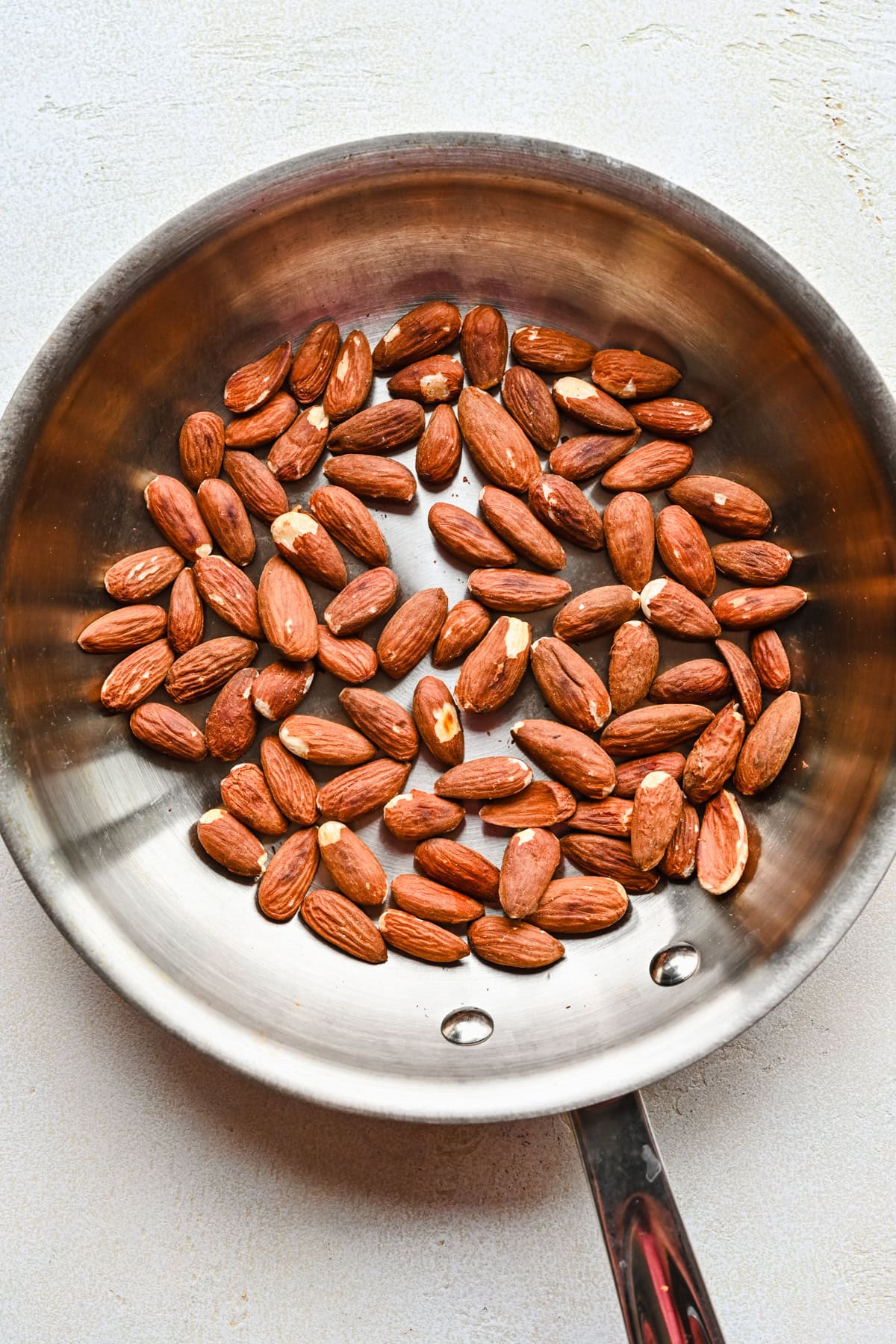 Toasted almonds in a pan.