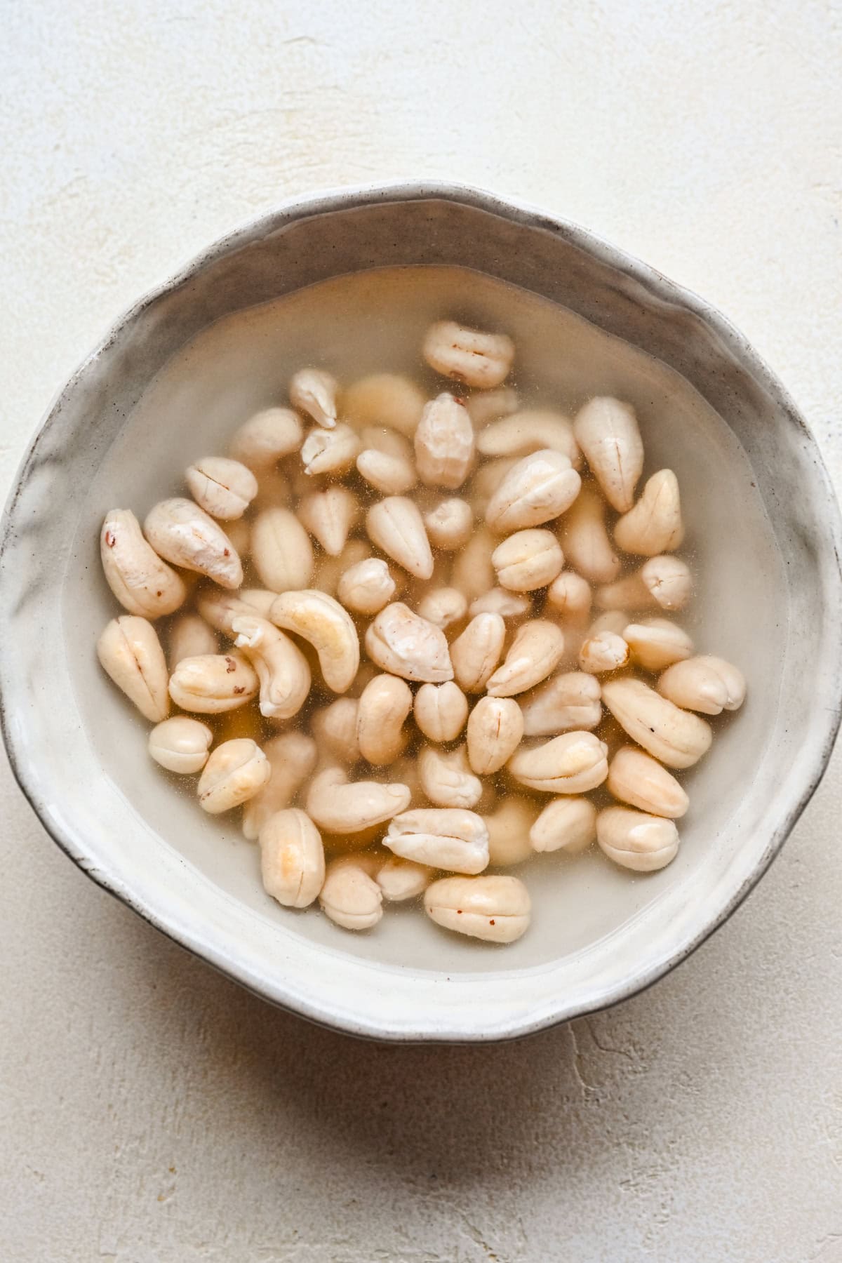 Cashews soaking in a bowl.