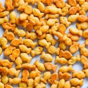 Overhead view of goldfish on parchment paper.