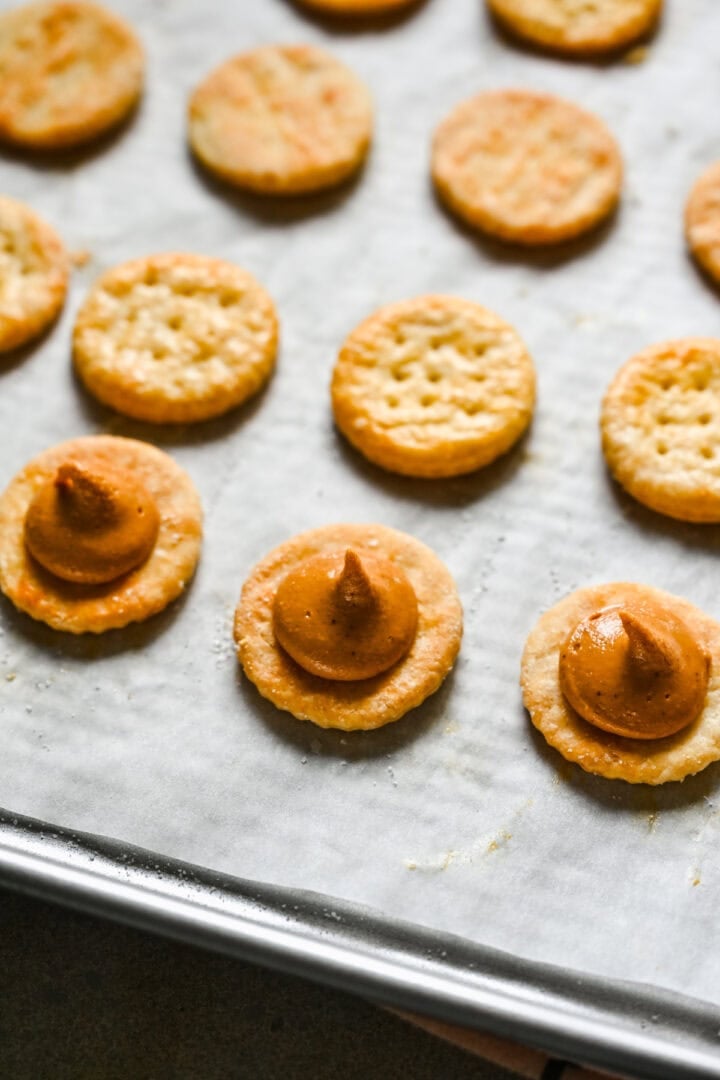 Overhead view of crackers with peanut butter piped in the middle.