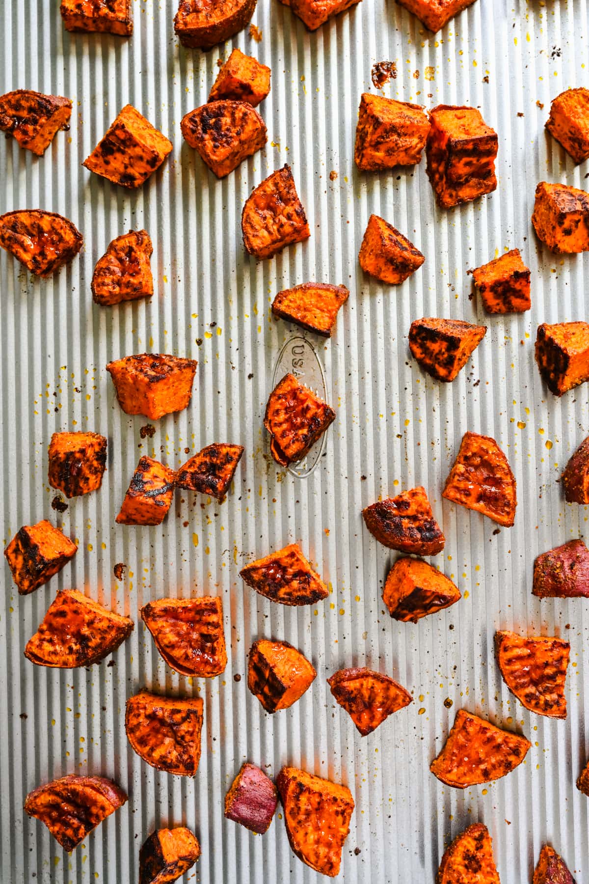 Cooked sweet potatoes on a sheet pan.