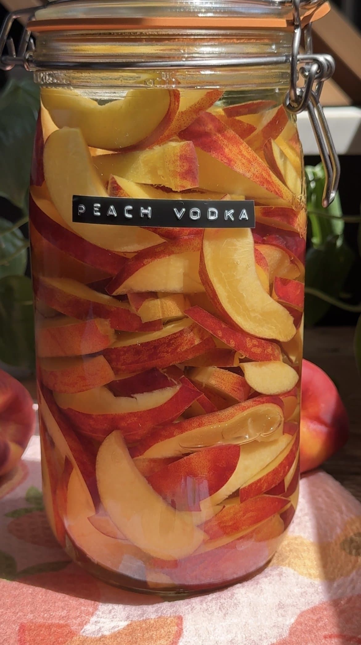 Close up view of peach vodka in a jar.