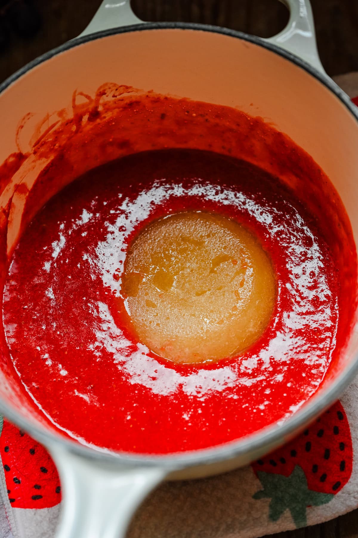 Melting gelatin in strawberry puree.