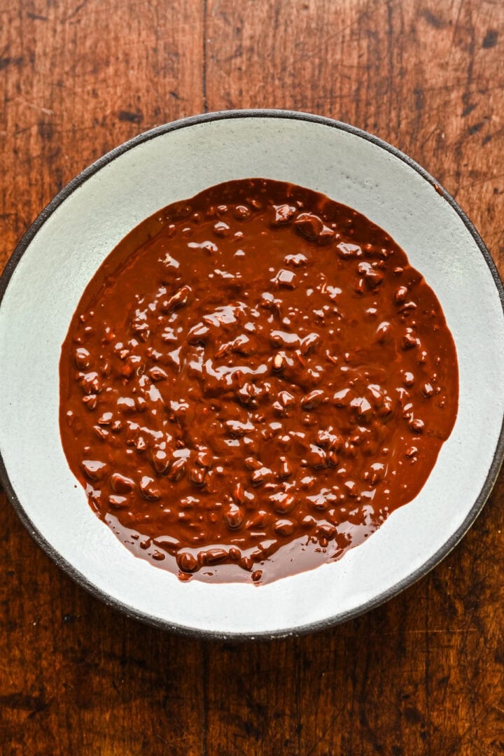 Finished bowl of chocolate and chopped peanut topping.