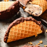 Cream-filled chocolate-dipped waffle cones with caramel and chocolate toppings, perfect for ice cream lovers.