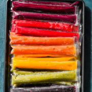 Overhead view of frozen popsicles on a sheet pan.