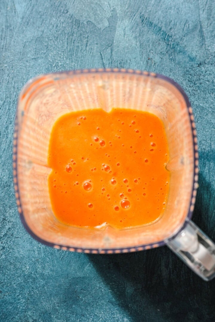 Overhead view of peach popsicle mixture.