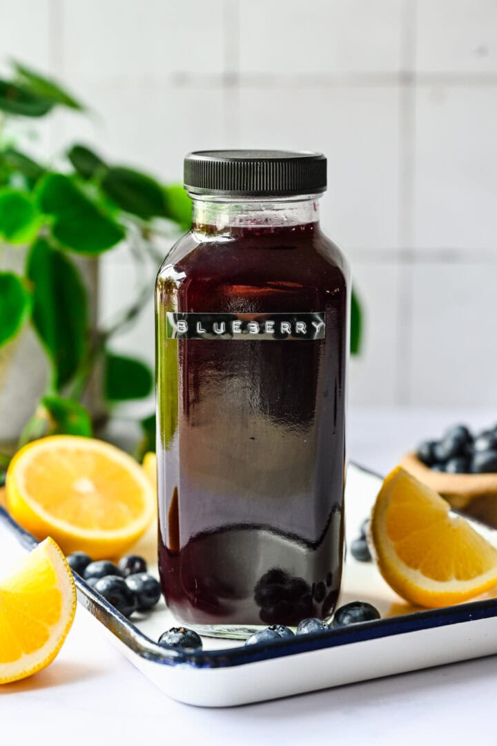 Front view of blueberry gatorade in a glass bottle