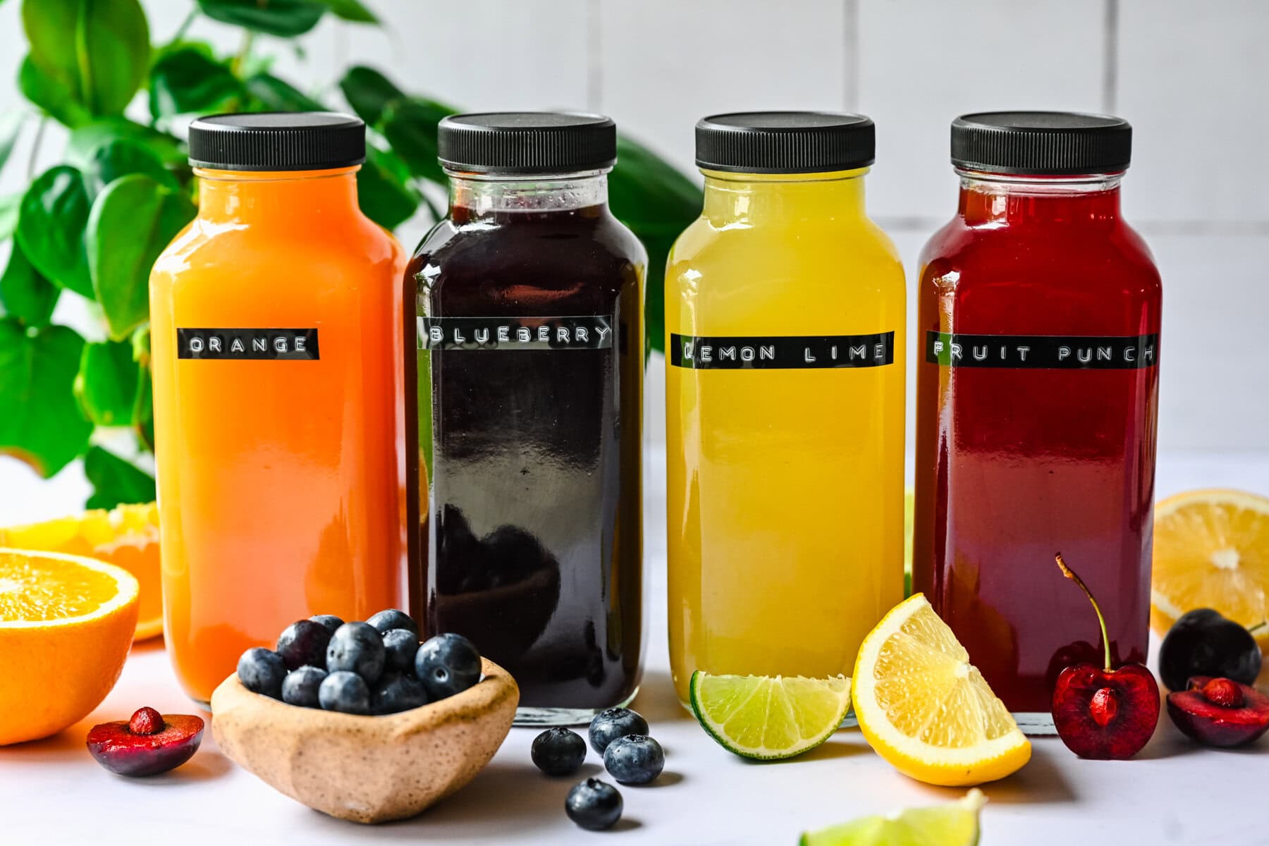 Front view of homemade gatorades in glass bottles.