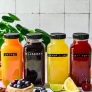 Front view of homemade gatorades in glass bottles.
