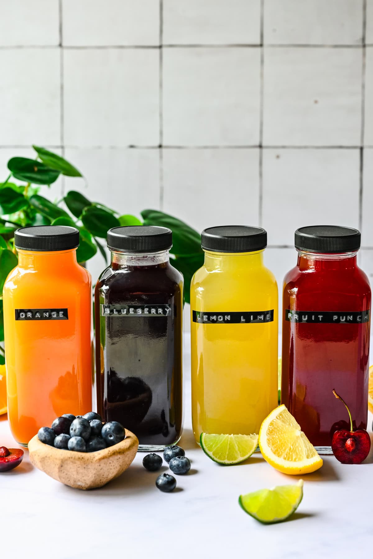 Front view of homemade gatorades in glass bottles.