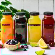 Front view of homemade gatorades in glass bottles.