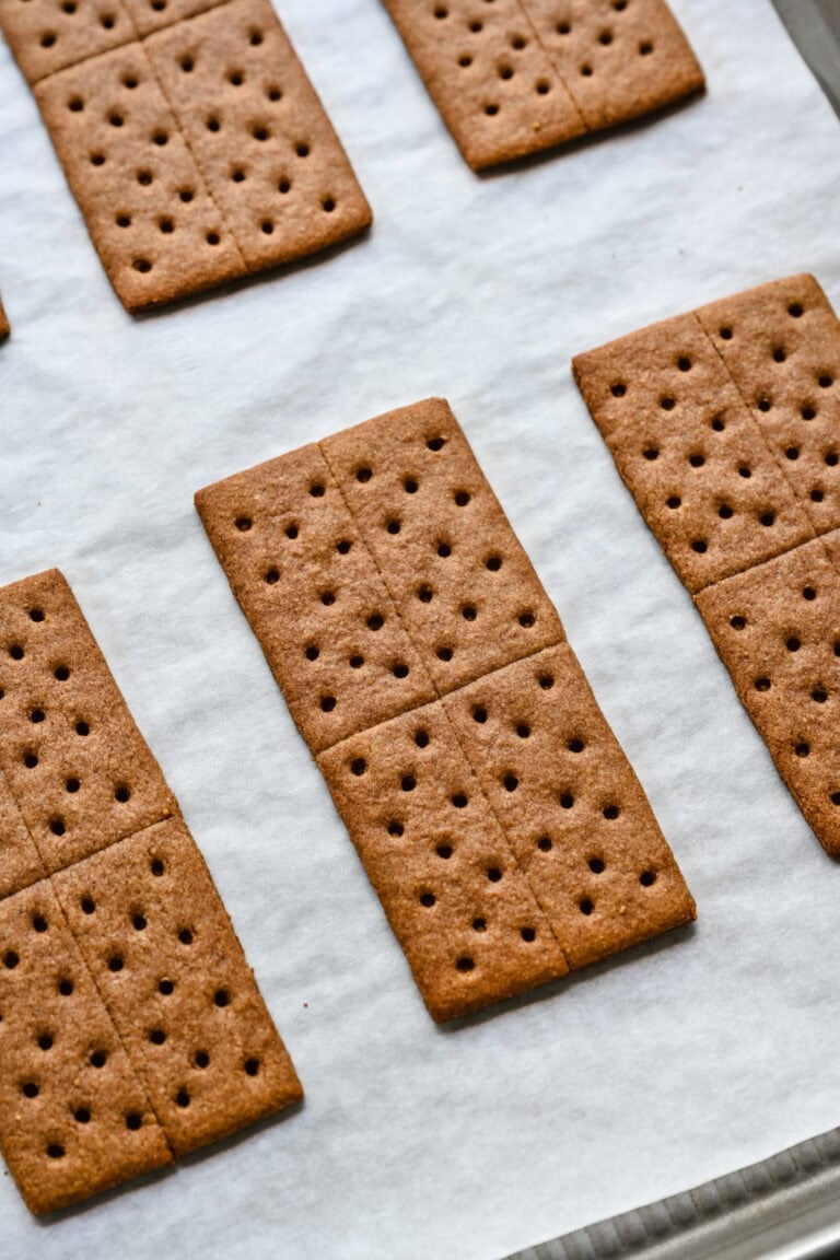 Golden brown graham crackers on baking sheet for homemade snacks or s'mores.