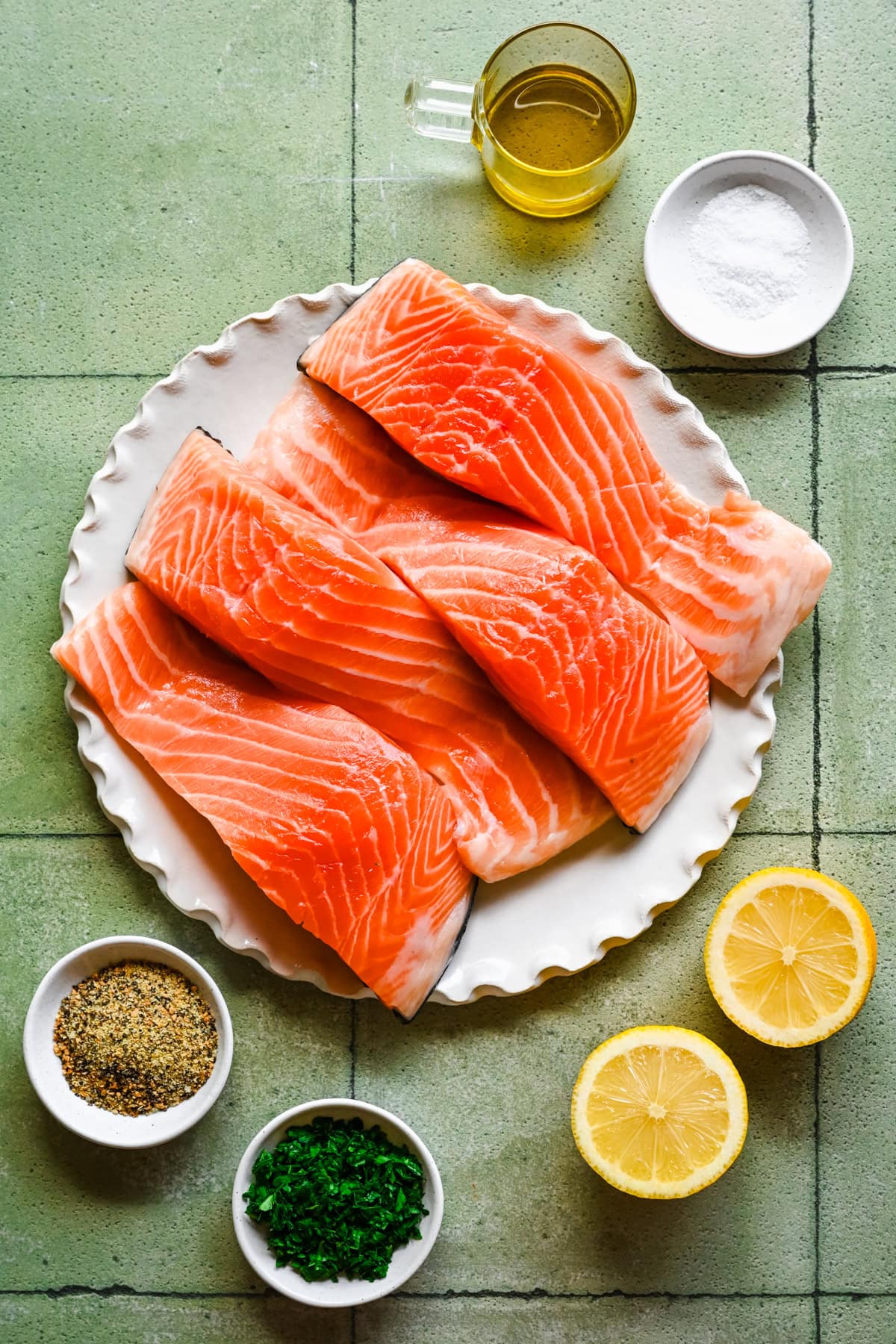 overhead view of ingredients for lemon pepper salmon in small bowls.