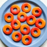Overhead view of peach rings on a blue plate.