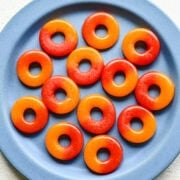 Overhead view of peach rings on a blue plate.