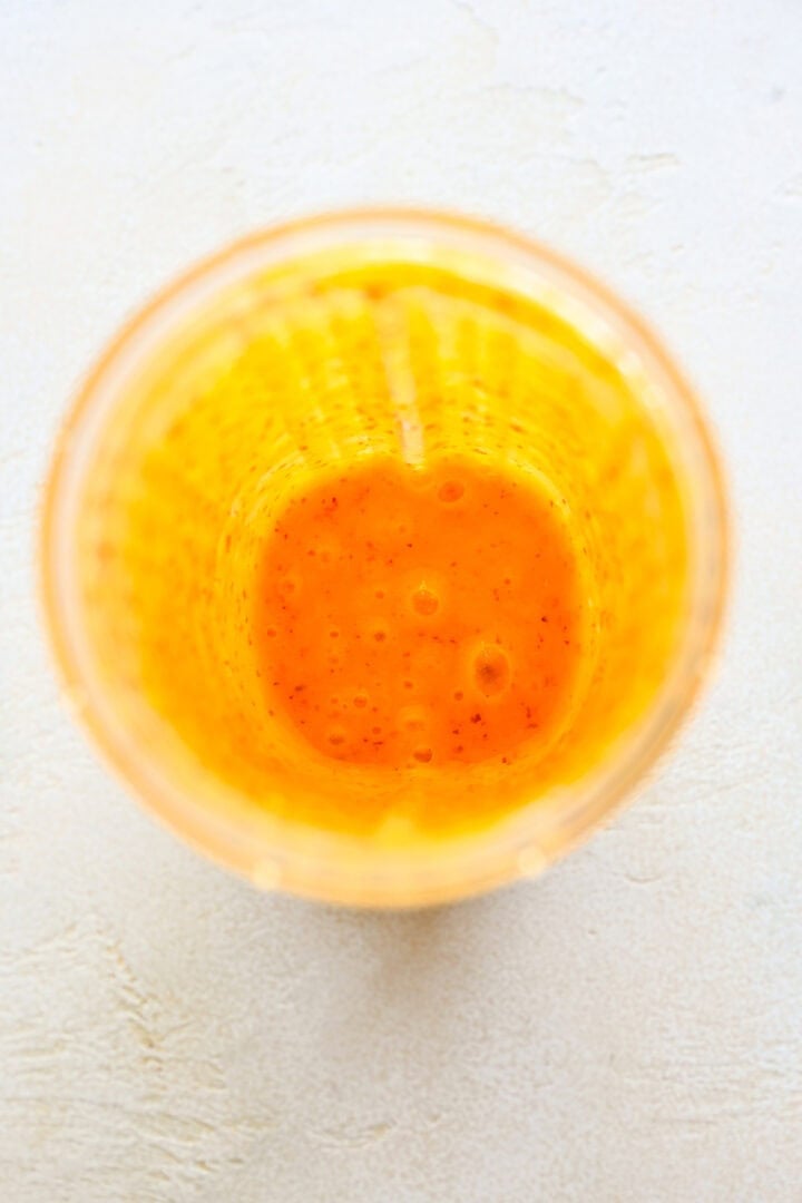 Overhead view of blended peach in a blender.