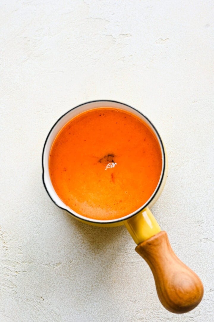 Pureed peach with honey in a pot.