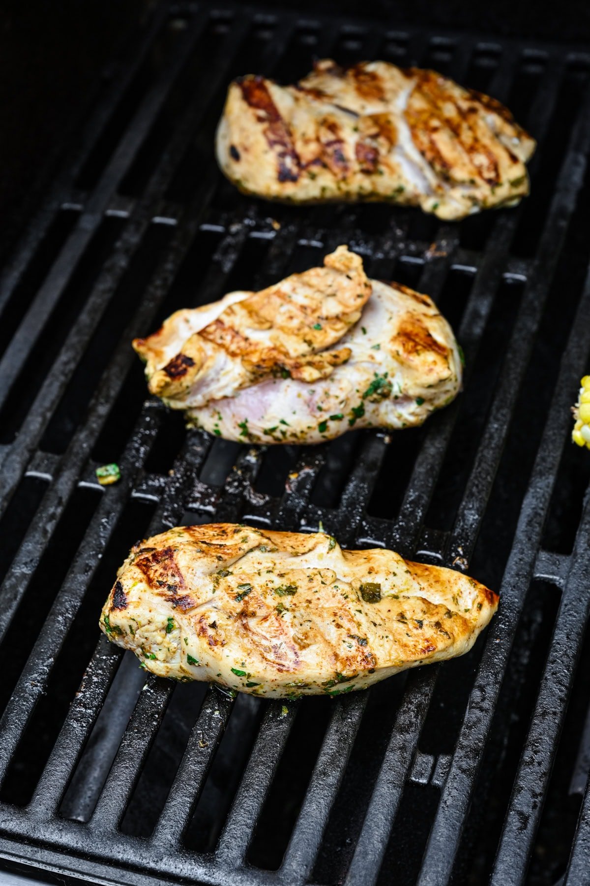 Chicken grilling on a grill.