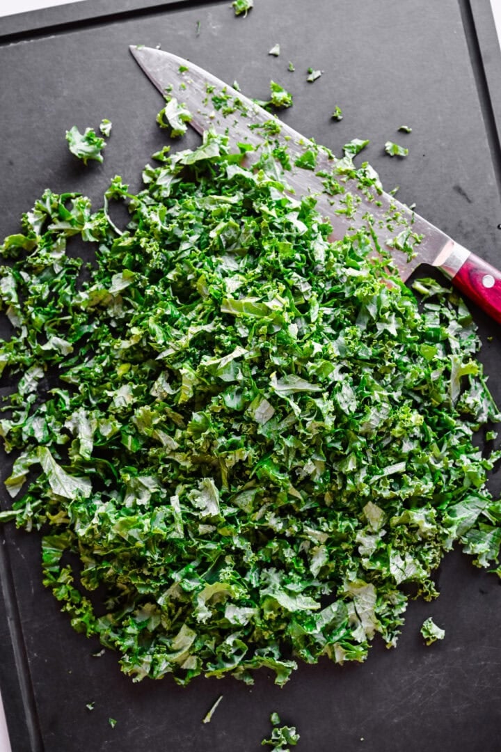 Overhead view of shredded kale on a cutting board.