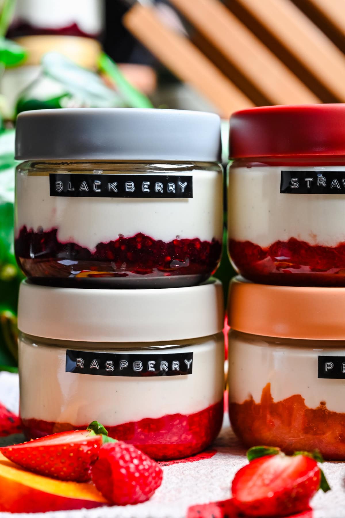 Front view of blackberry and raspberry yogurt in jars.