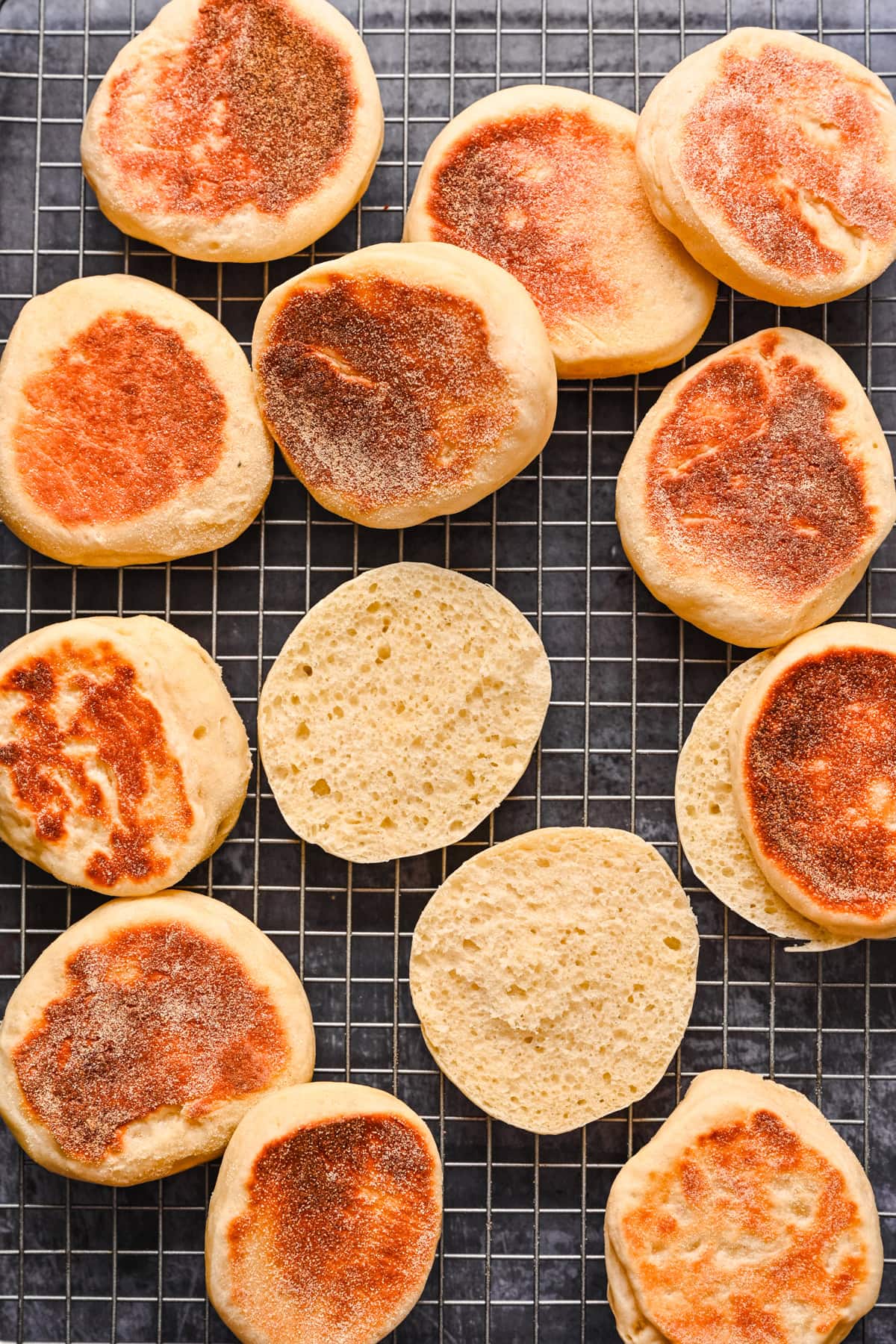 Overhead view of english muffins on a cooling rack.