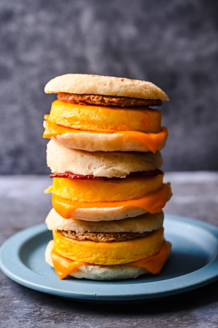 Front view of 3 egg sandwiches stacked on top of one another.