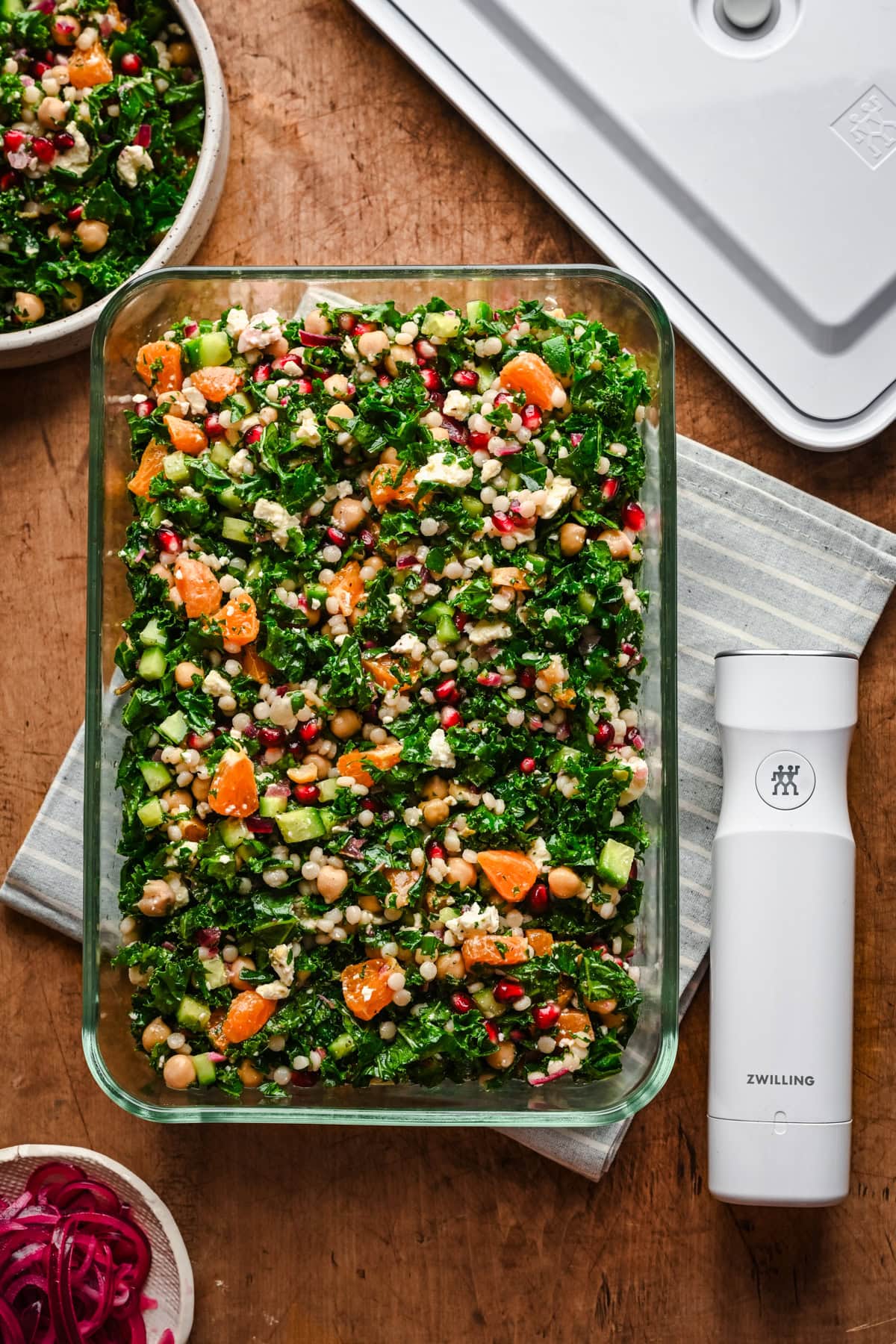 overhead view of kale couscous salad in glass container.