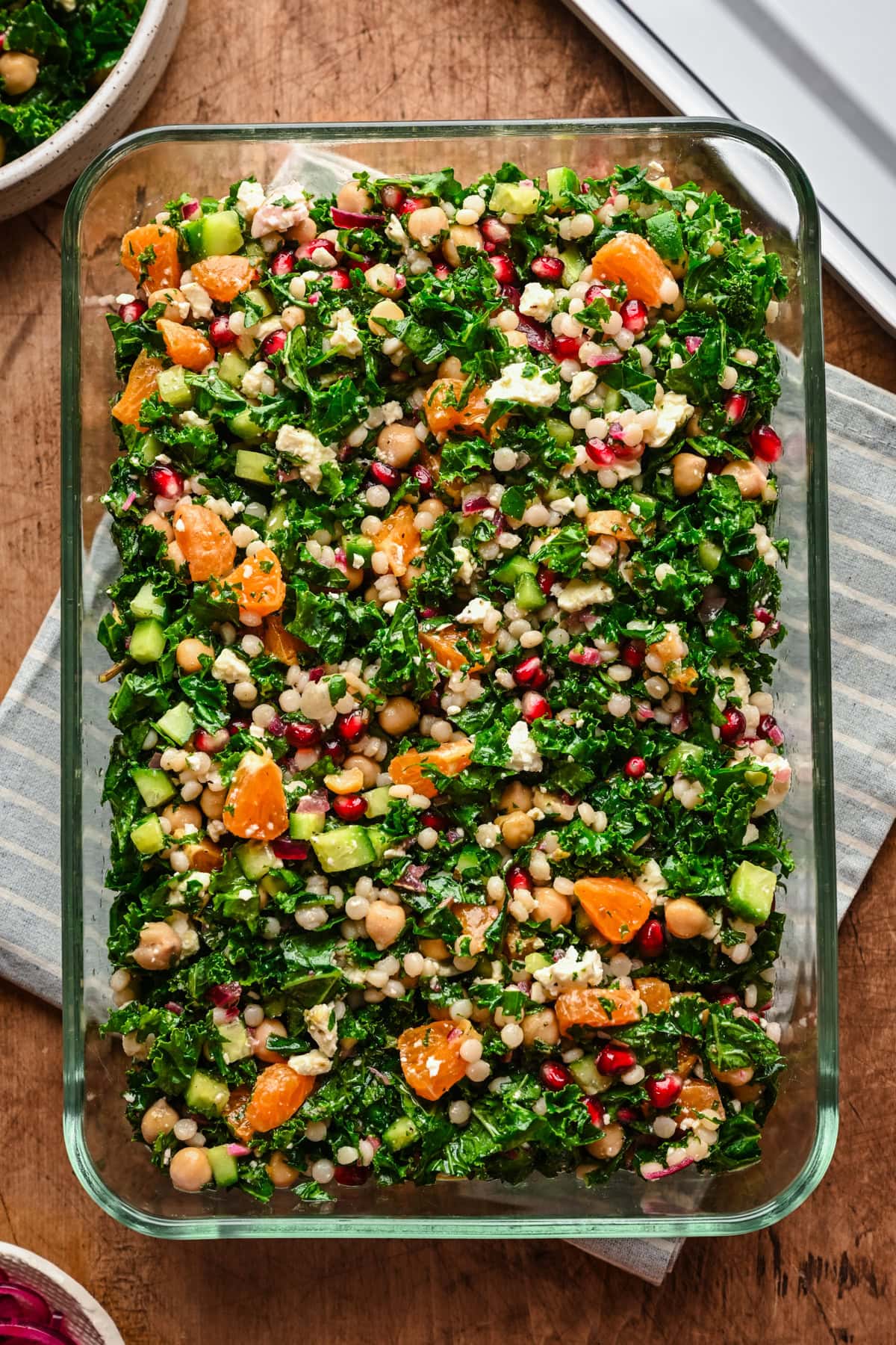 overhead view of kale couscous salad in glass container.