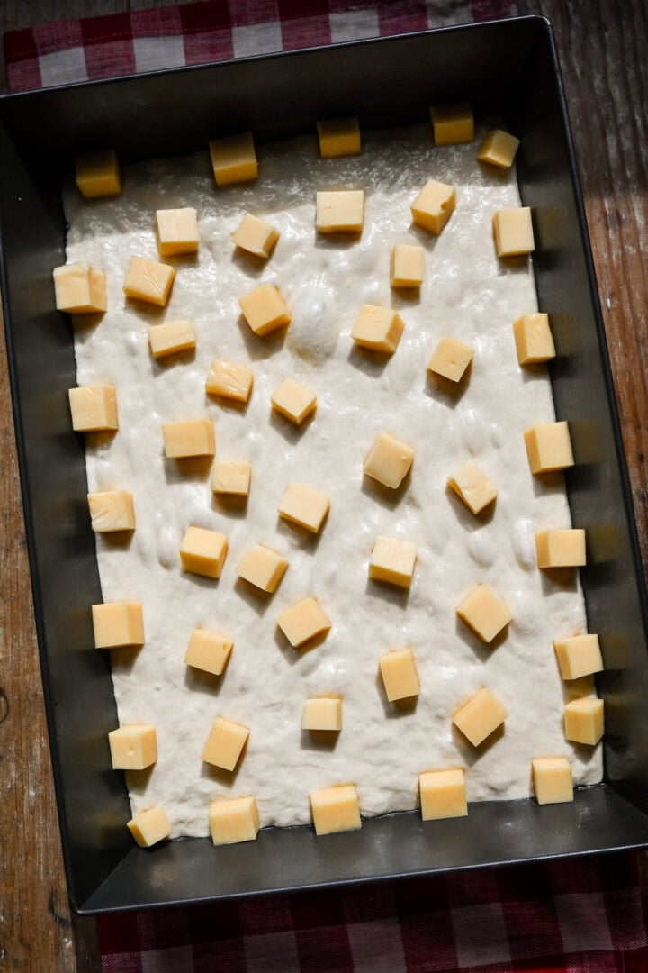 Overhead view of pizza after adding cheese.