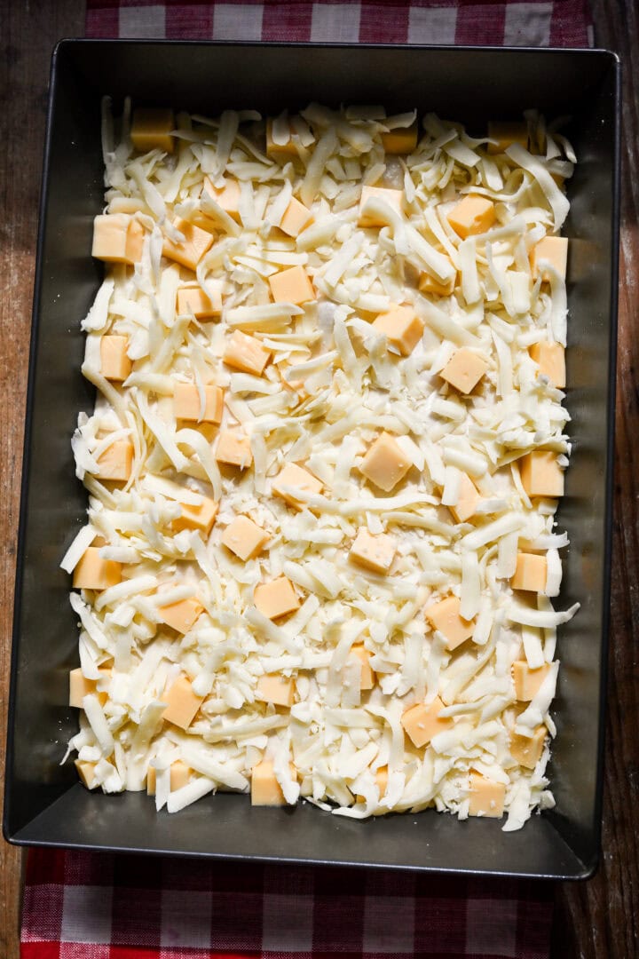 Overhead view of pizza after adding cheese.