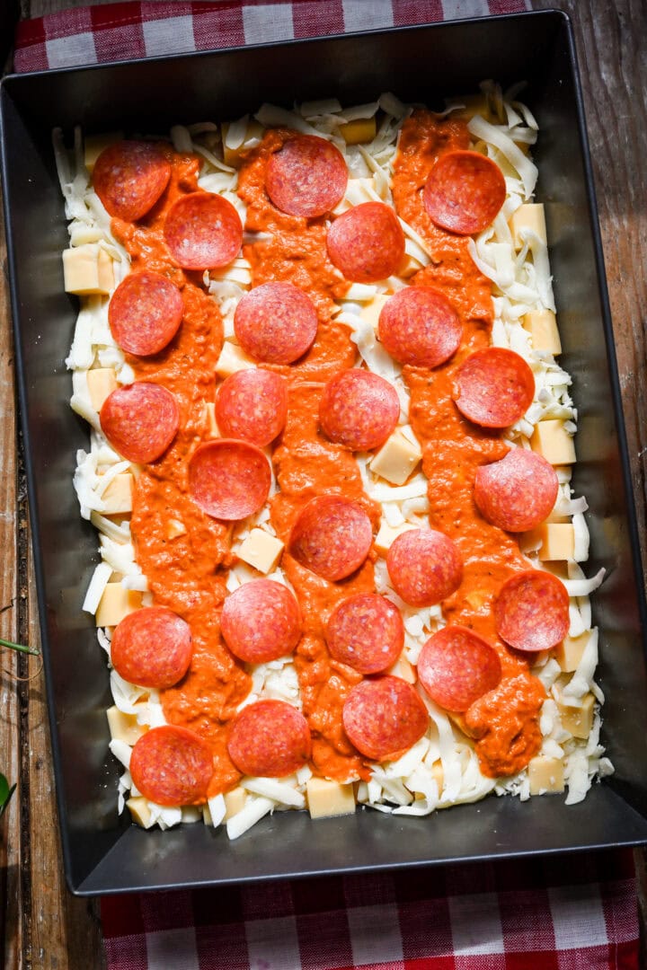 Overhead view of pizza in a pan before baking.