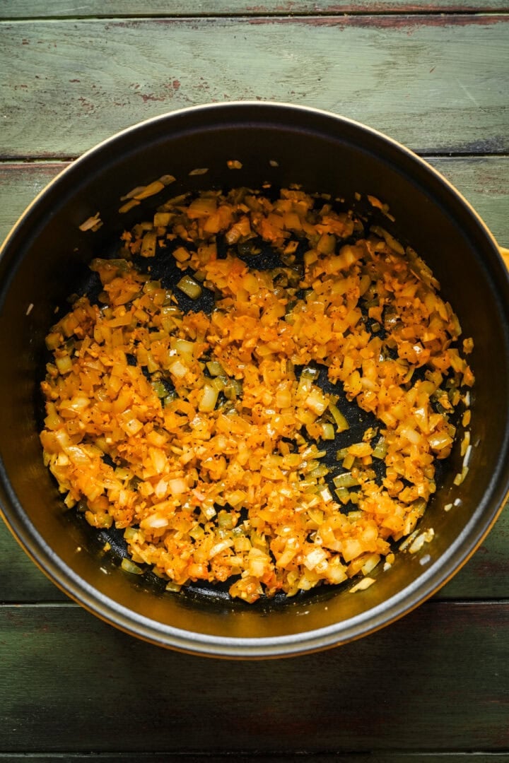 Onions cooking a cast iron pot.