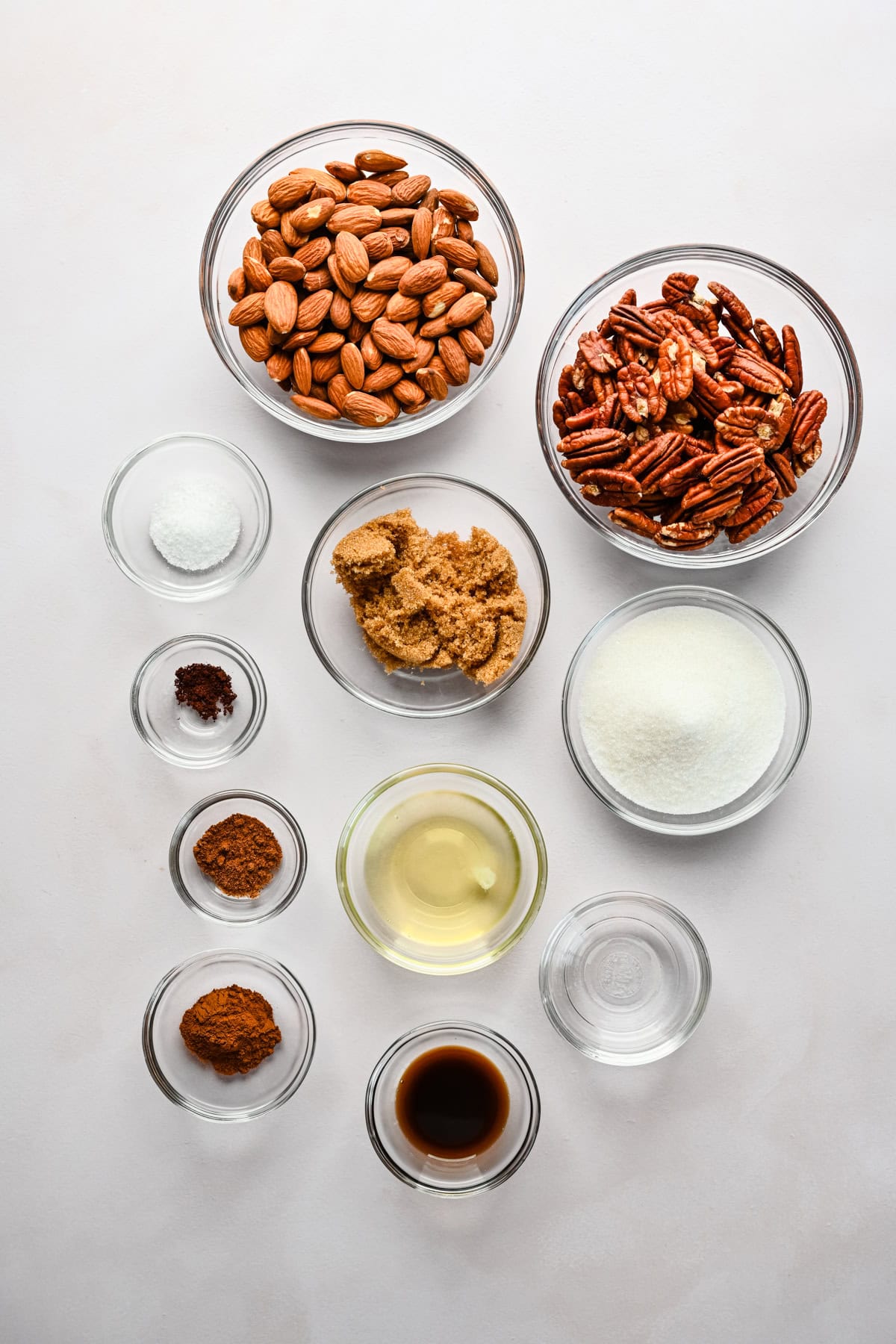 Overhead view of candied nuts ingredients, including pecans and sugar.