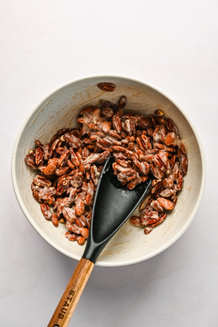 Candied nuts in a bowl with a spoon isnde.