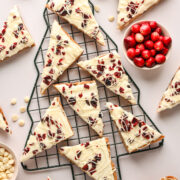 Overhead view cranberry bliss bars on christmas tree shaped baking rack.