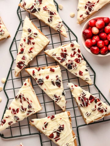 Overhead view cranberry bliss bars on christmas tree shaped baking rack.