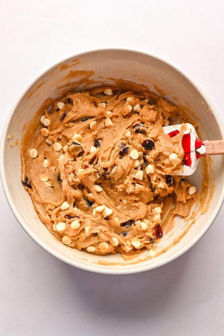 Overhead view of cranberry white chocolate blondie batter in bowl.