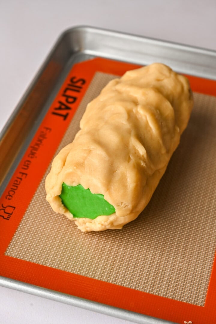 Log of colored shapes after putting dough around it.