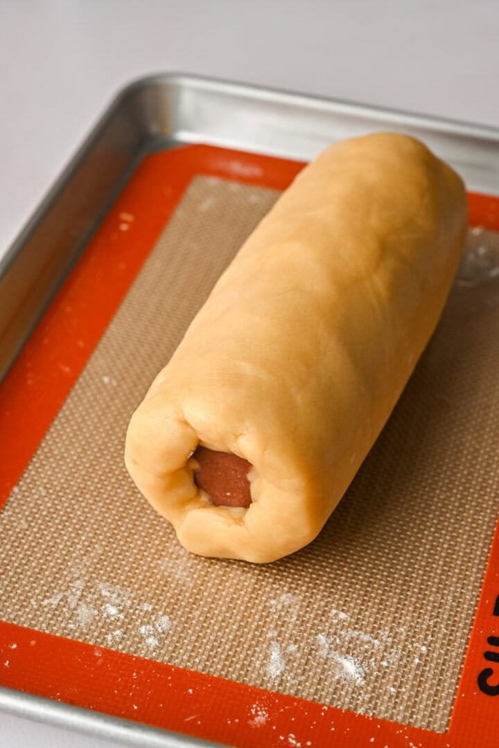 Log of colored shapes after putting dough around it.