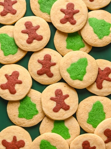 Gingerbread men and christmas tree cookies on a sheet pan.