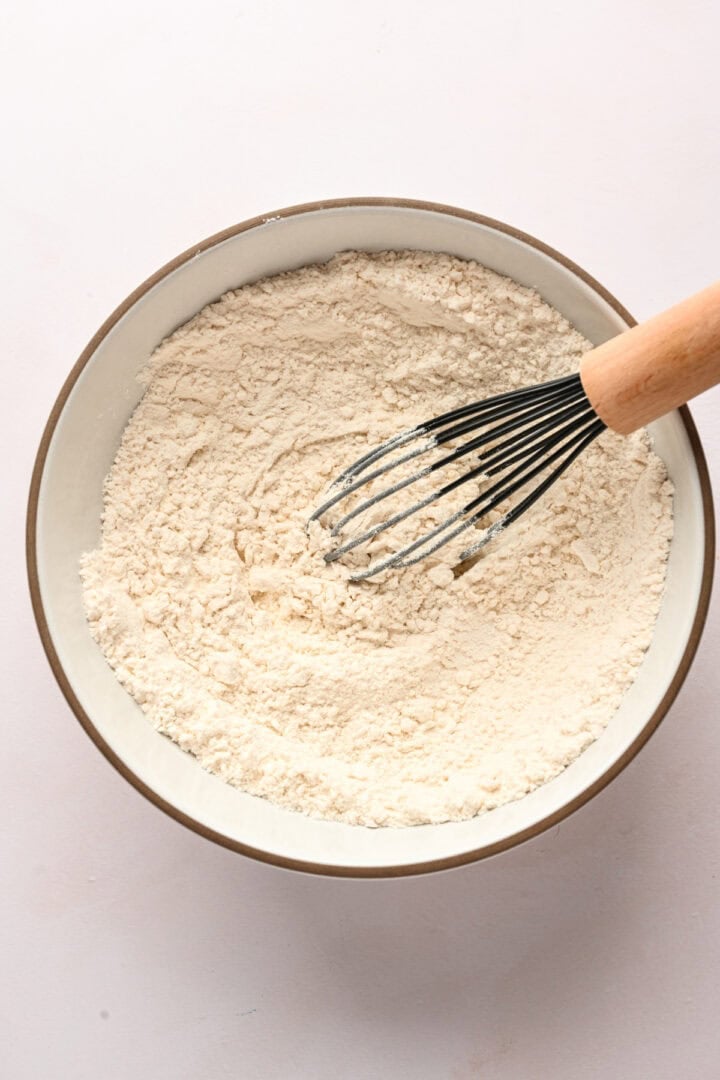 Bowl that contains whisked flour, baking powder, and salt.