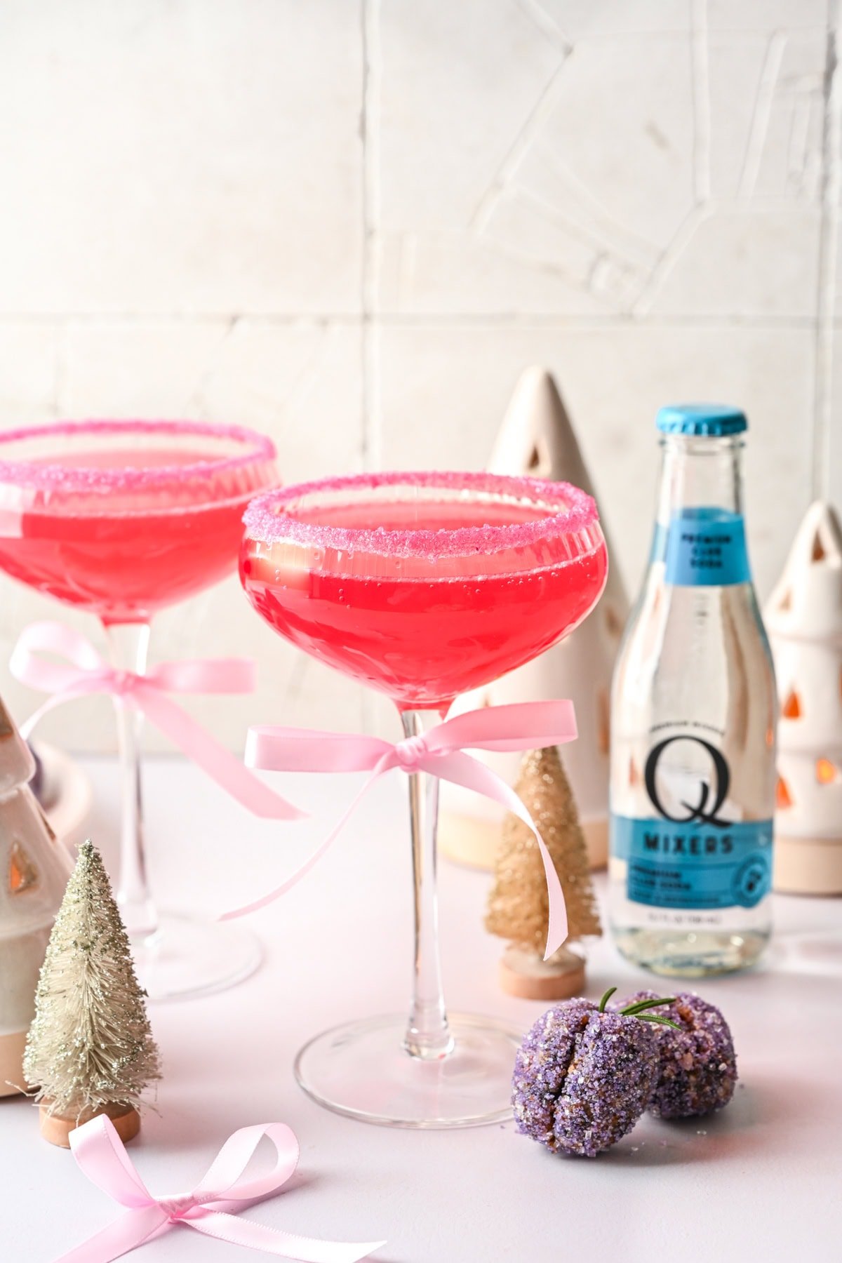 Front view of pink cocktail in a coupe glass.