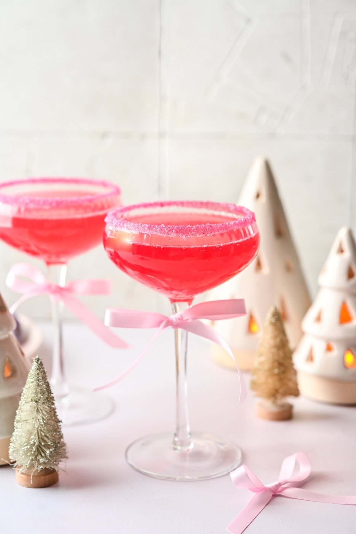 Front view of pink cocktail in a coupe glass.