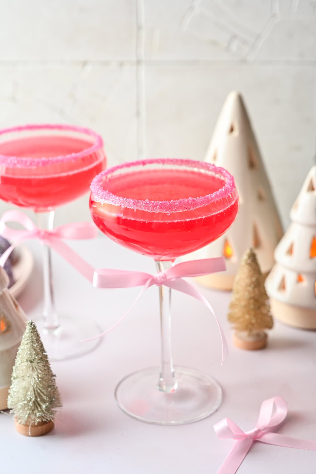 Front view of pink cocktail in a coupe glass.