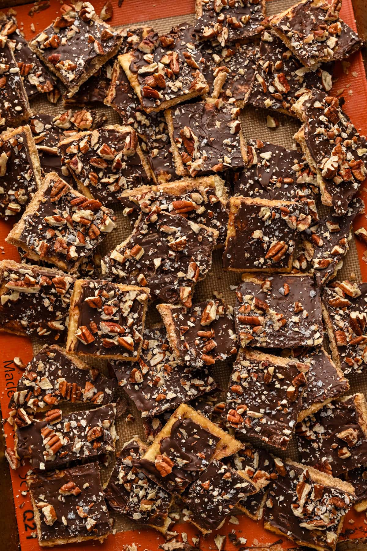 Overhead view of bourbon pecan christmas crack on a sheet pan.