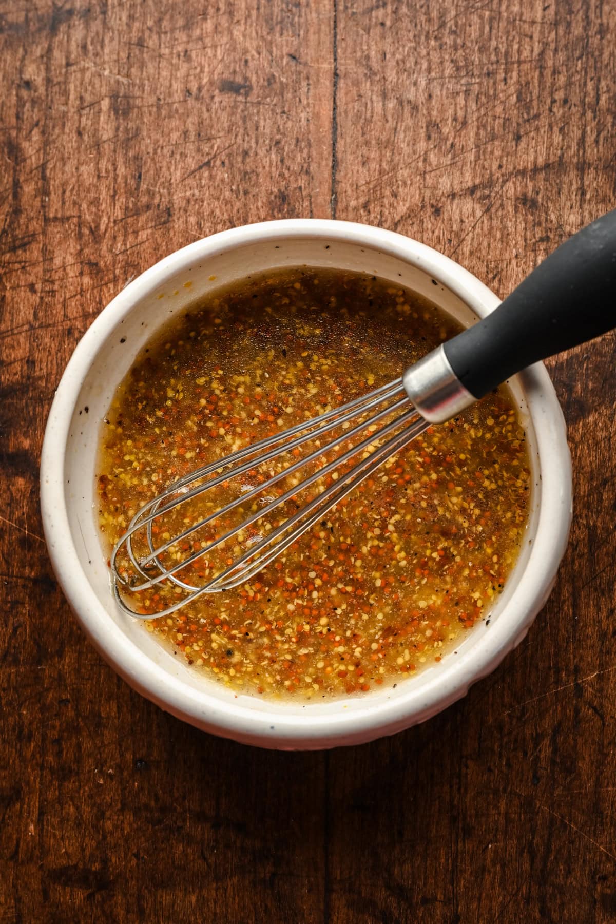 Whole grain mustard vinaigrette in a bowl.