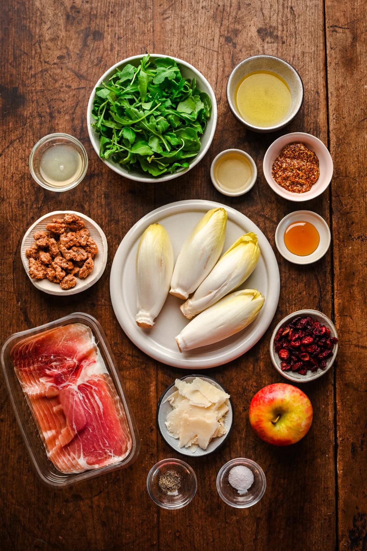 Overhead view of ingredients for Christmas wreath salad on wood table.