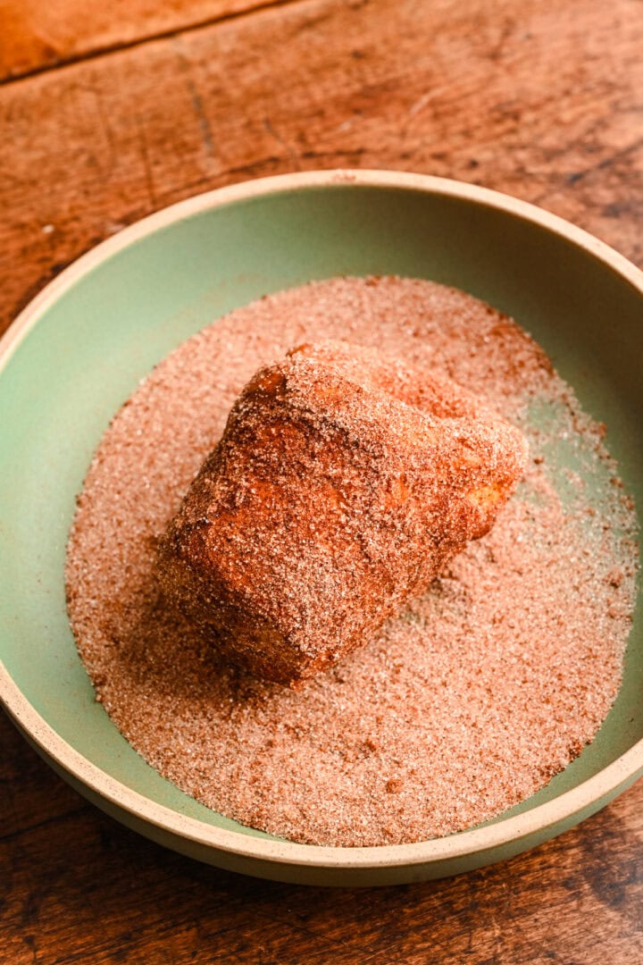 Coating popover in cinnamon sugar.
